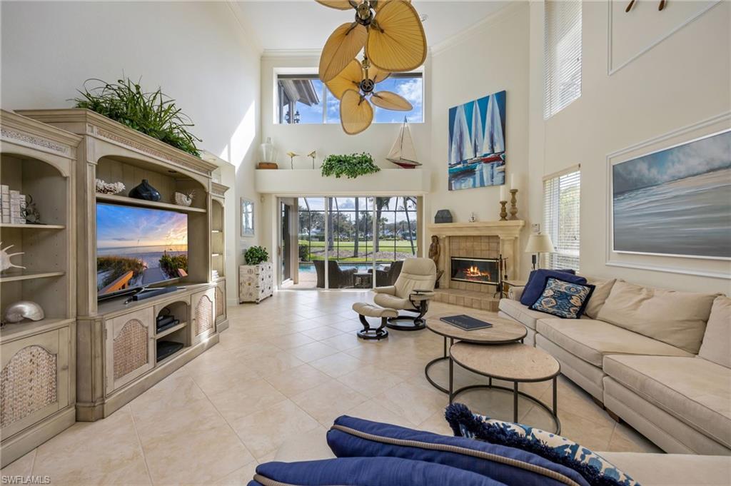 6012 Fairway Court Naples, FL 34110 - Photo 7 of 38 a living room with furniture and a fireplace