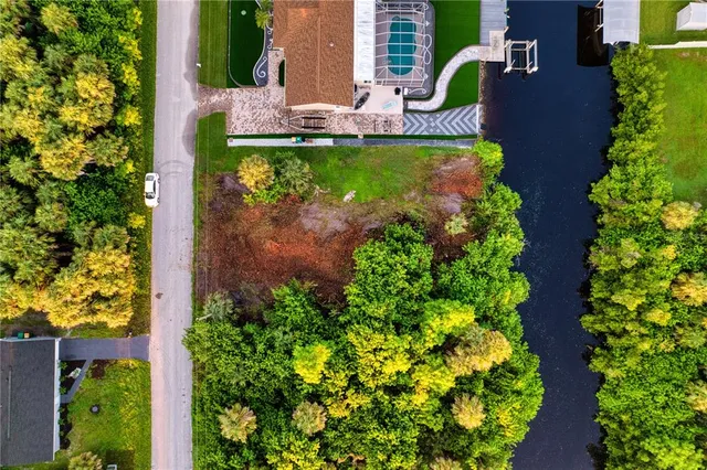 an aerial view of a house with a yard and garden