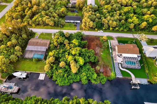 an aerial view of a house with a yard