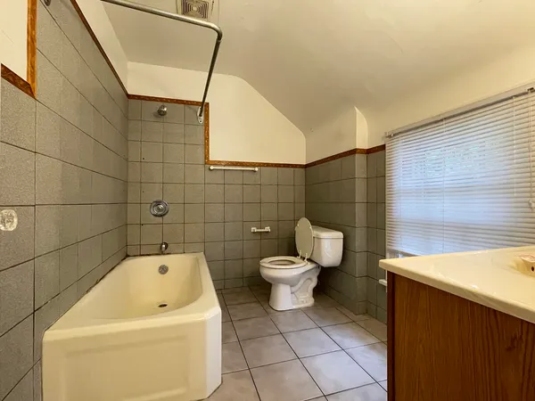 a bathroom with a toilet and a bathtub
