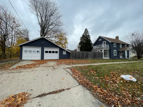a view of a house with a yard covered with snow in front of it