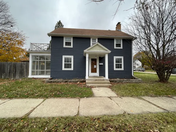 a front view of a house with a garden