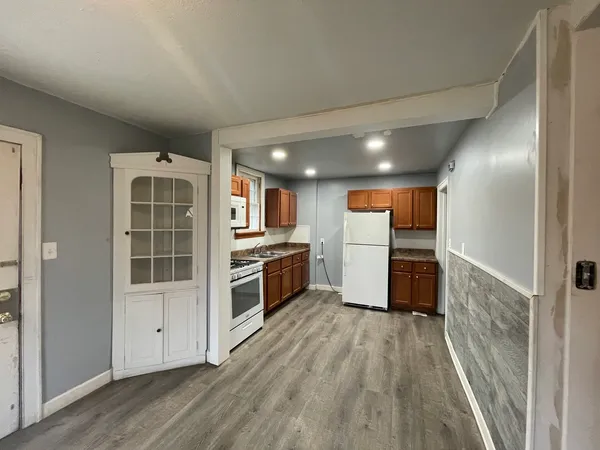 a view of kitchen with sink and wooden floor