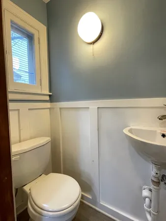 a white toilet sitting next to a bathroom sink
