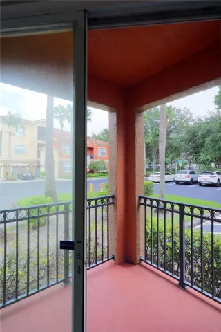 a view of balcony and floor to ceiling window