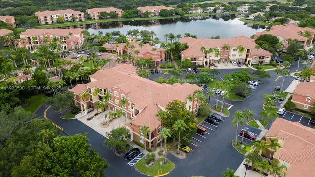 an aerial view of a house with a garden and lake view