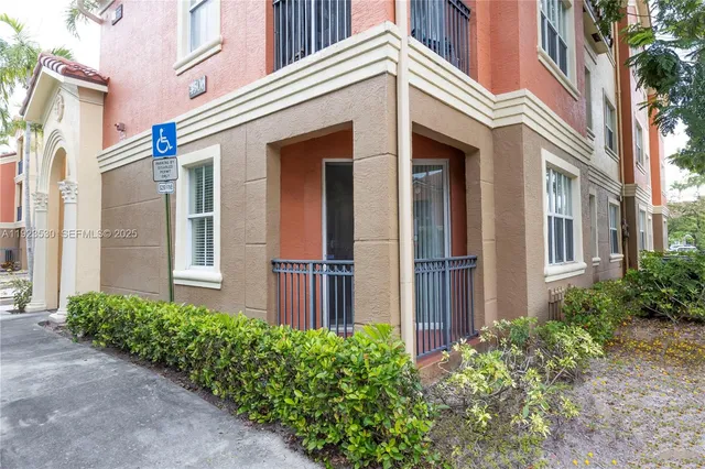 a front view of a house with a yard and plants