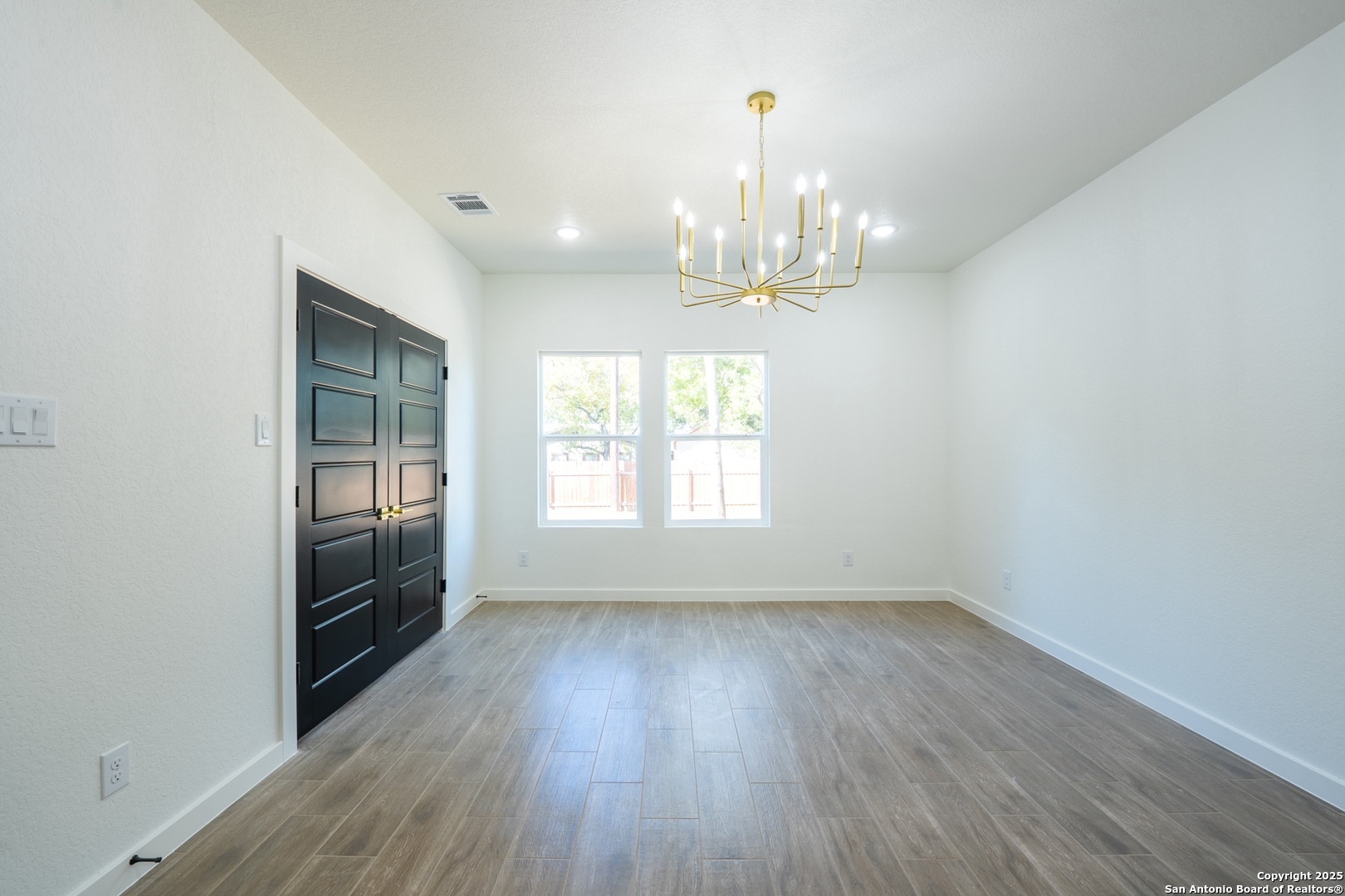 20035 Morrison Street Somerset, TX 78069 - Photo 12 of 25 wooden floor in an empty room with a window