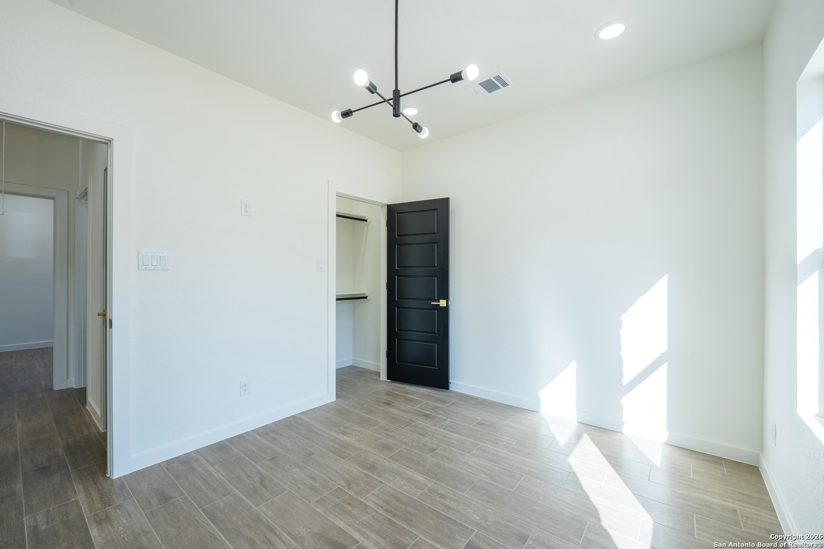 20035 Morrison Street Somerset, TX 78069 - Photo 18 of 25 a view of empty room with wooden floor and fan