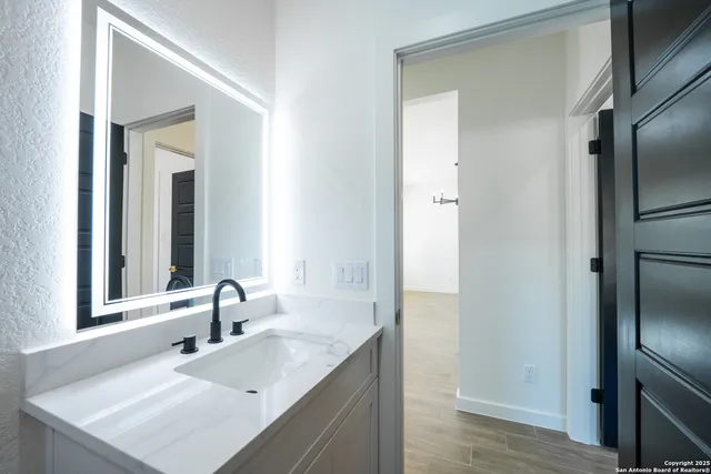 a bathroom with a sink and a mirror