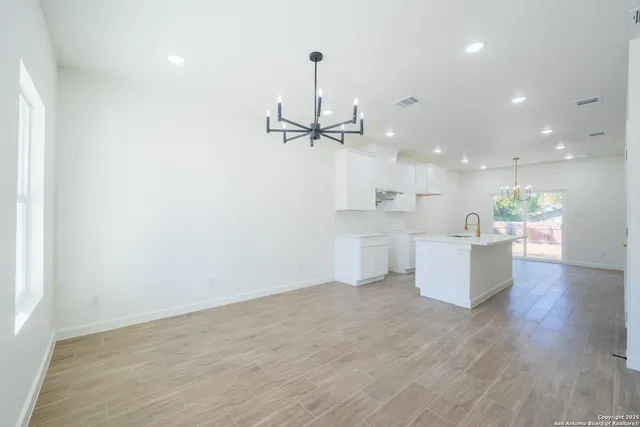 a view of a kitchen with a sink stainless steel appliances and a window