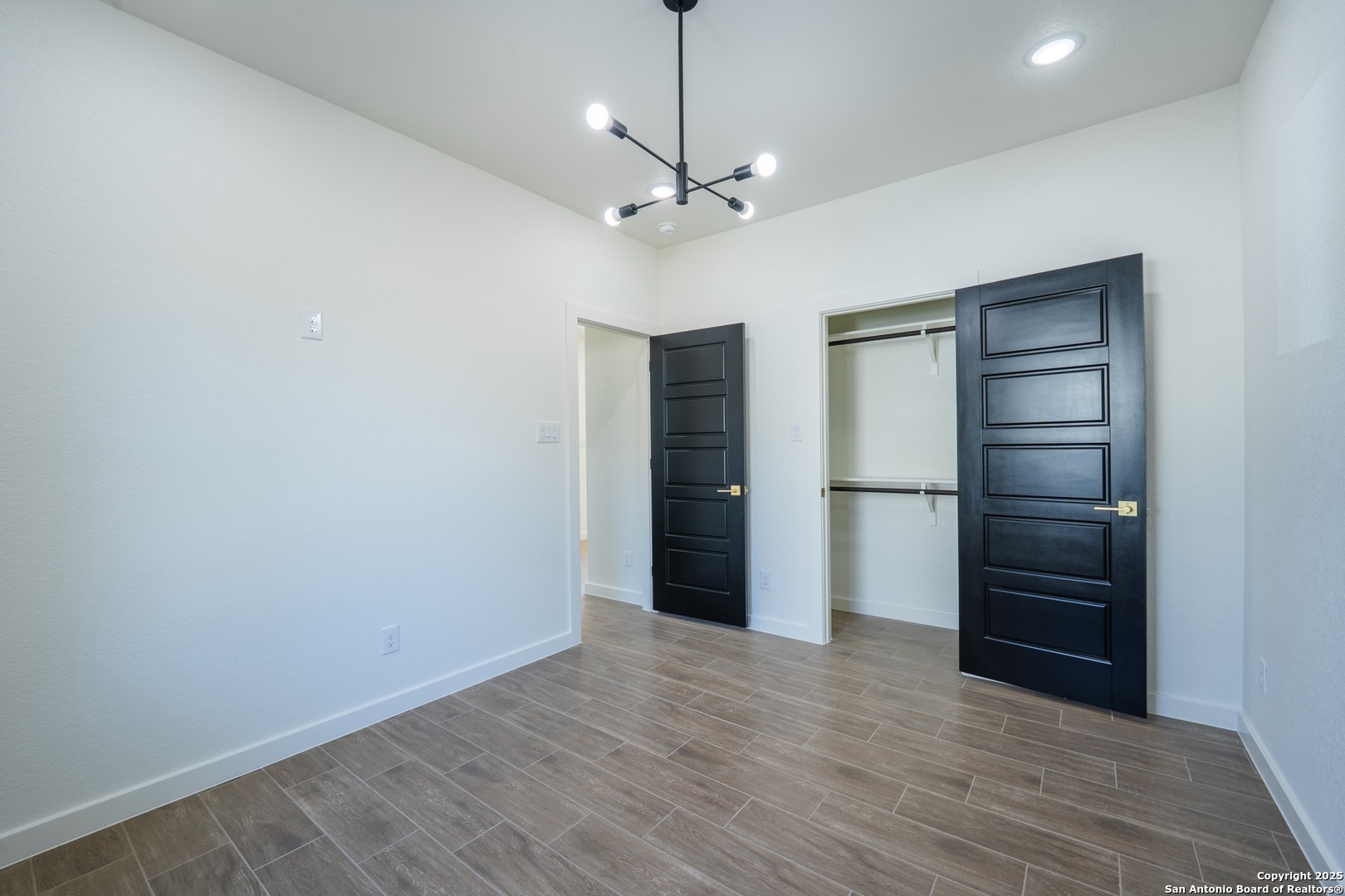 20035 Morrison Street Somerset, TX 78069 - Photo 22 of 25 a view of an empty room with a ceiling fan closet and a ceiling fan