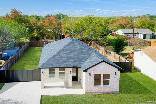 a view of a house with backyard porch and sitting area