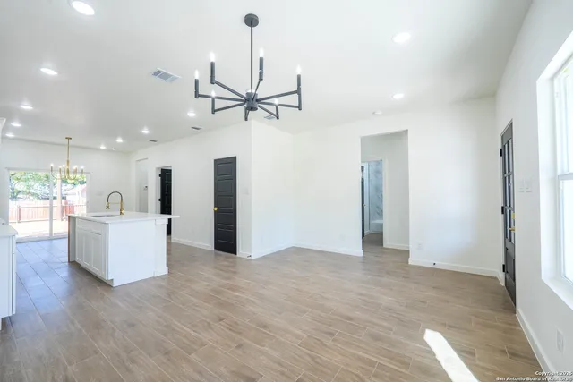 a view of a kitchen with a sink and refrigerator