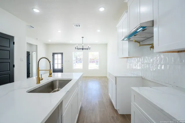 a kitchen with a sink a counter space and stainless steel appliances
