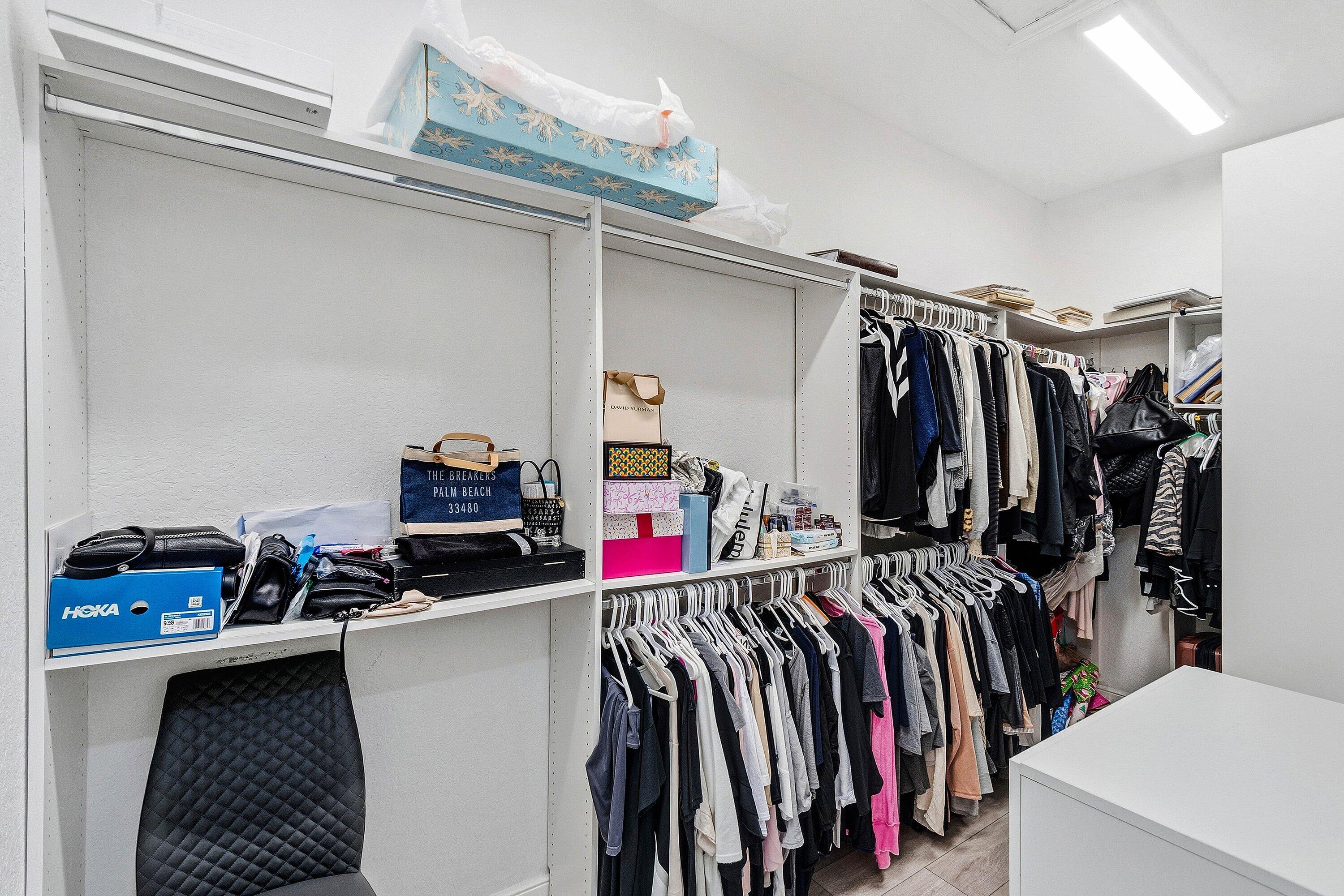 2358 Northwest 49th Lane Boca Raton, FL 33431 - Photo 23 of 47 a view of walk in closet with clothes and shoes