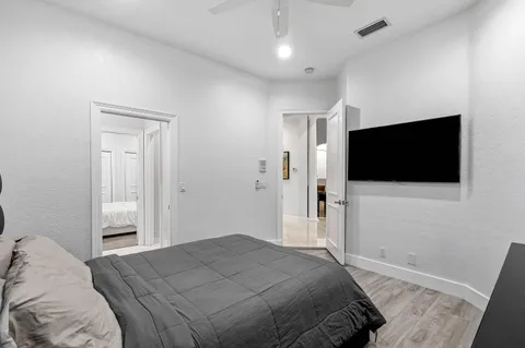 a bedroom with a bed and a flat screen tv