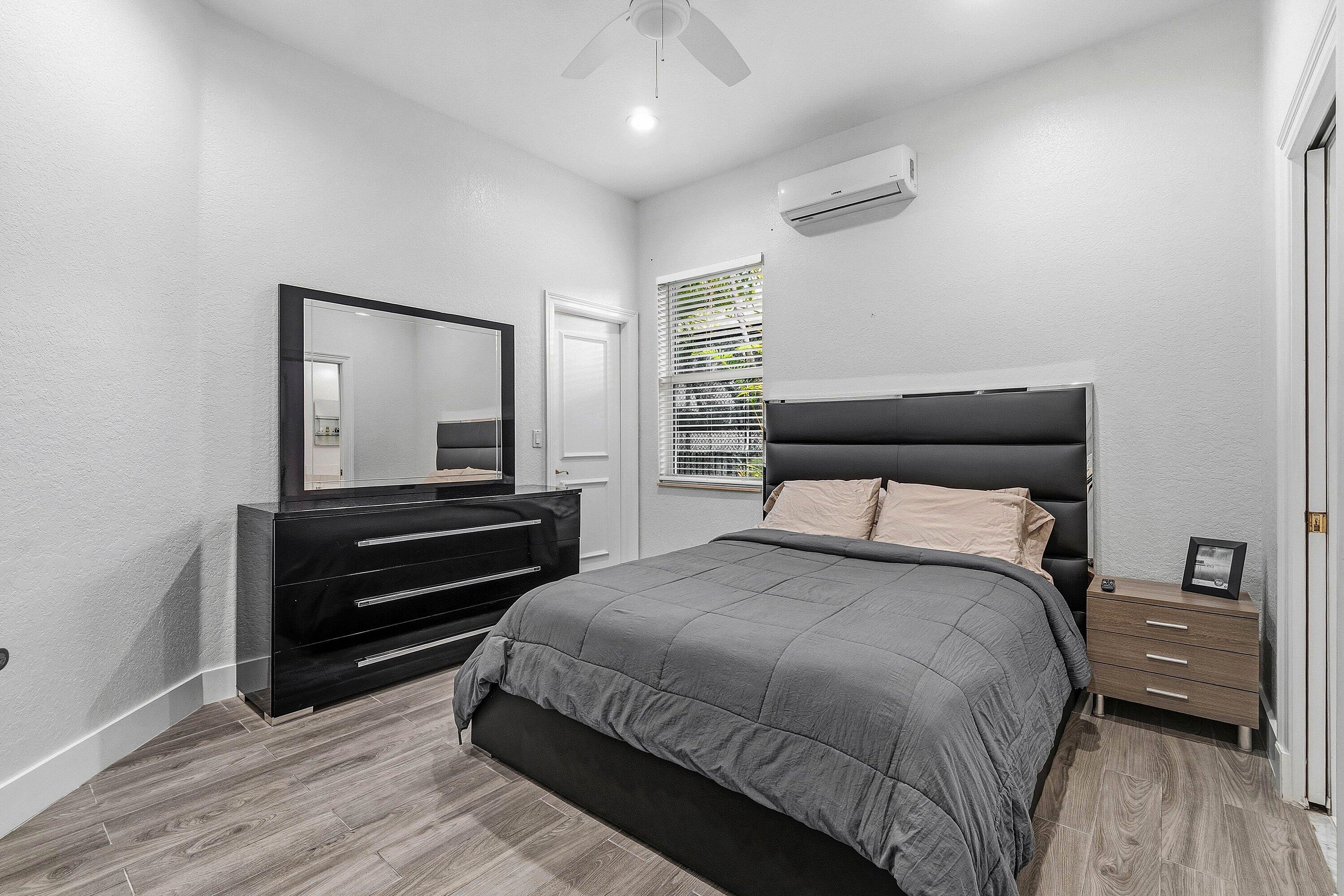 2358 Northwest 49th Lane Boca Raton, FL 33431 - Photo 28 of 47 a bedroom with a bed and a wooden floor