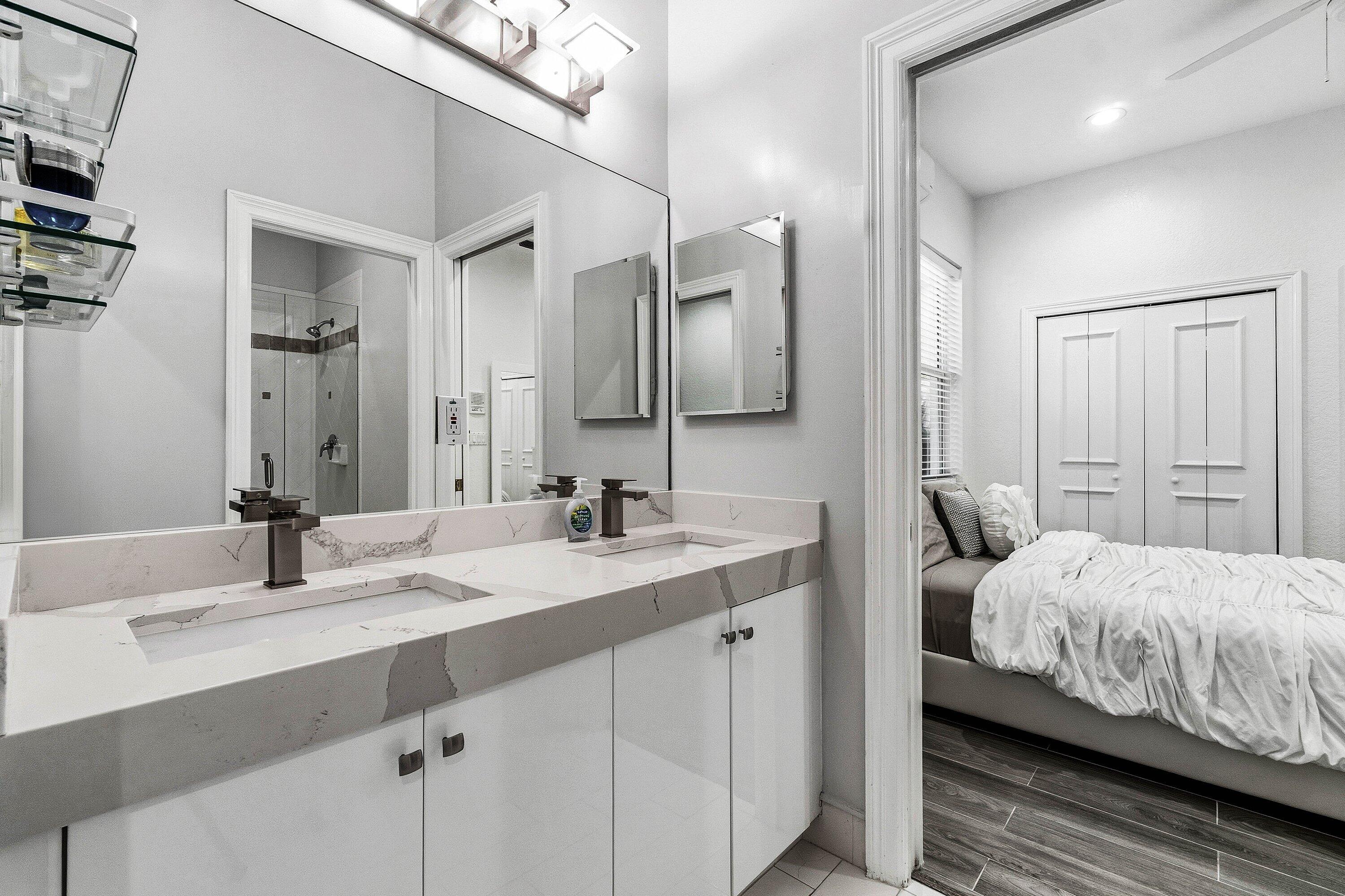 2358 Northwest 49th Lane Boca Raton, FL 33431 - Photo 30 of 47 a en suite bathroom with a double vanity sink and mirror