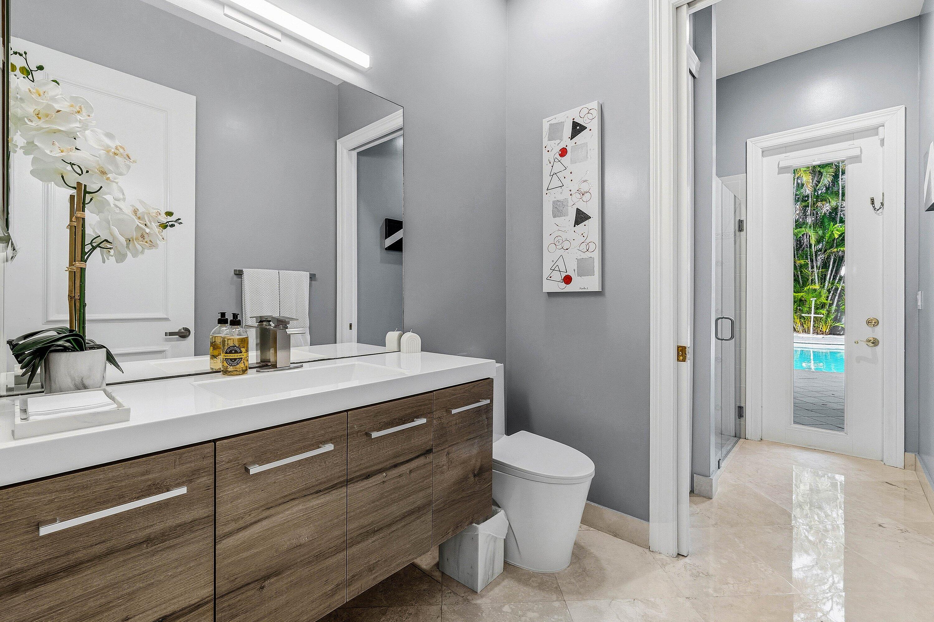 2358 Northwest 49th Lane Boca Raton, FL 33431 - Photo 34 of 47 a bathroom with a granite countertop sink a toilet and shower