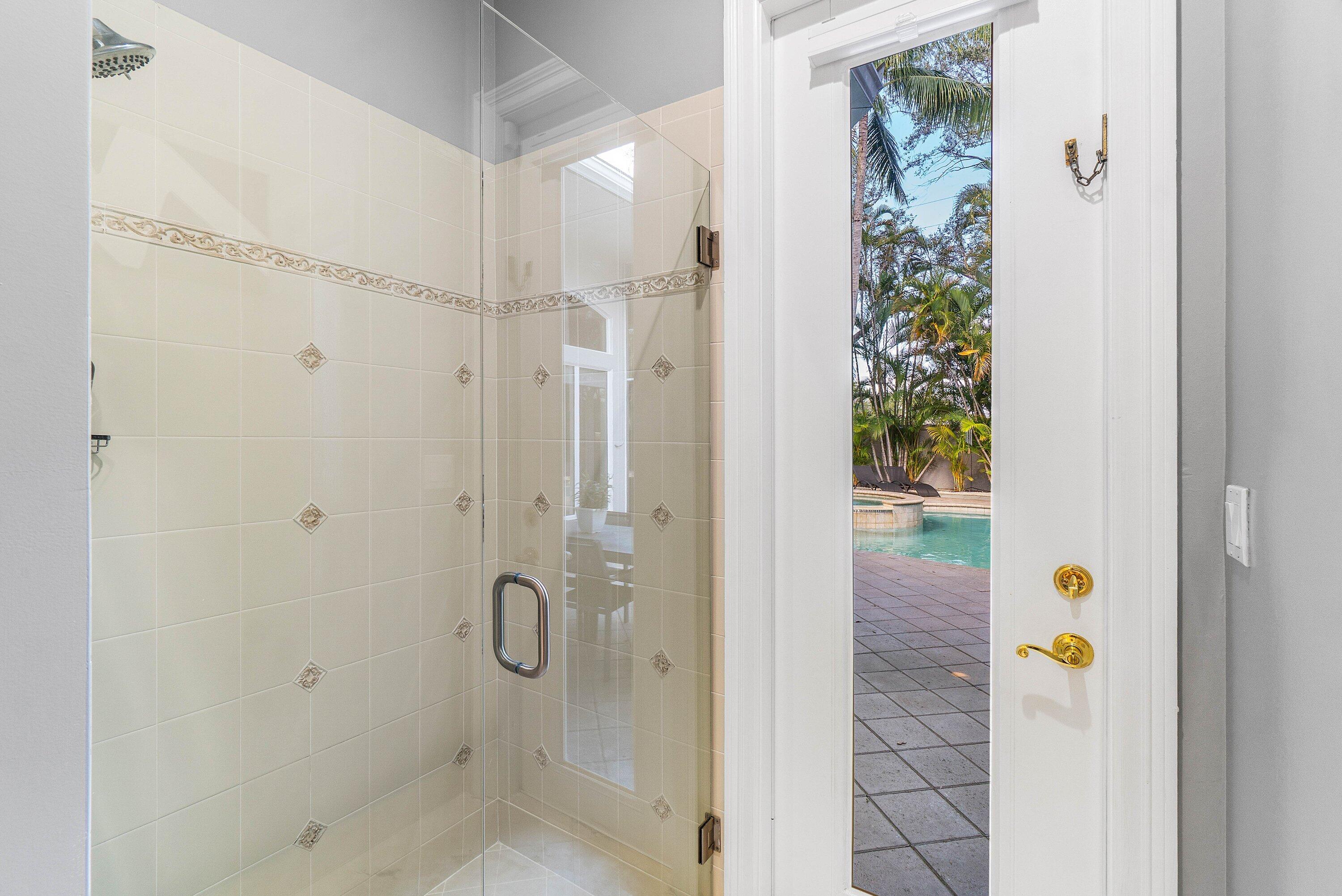 2358 Northwest 49th Lane Boca Raton, FL 33431 - Photo 35 of 47 a bathroom with a glass shower door