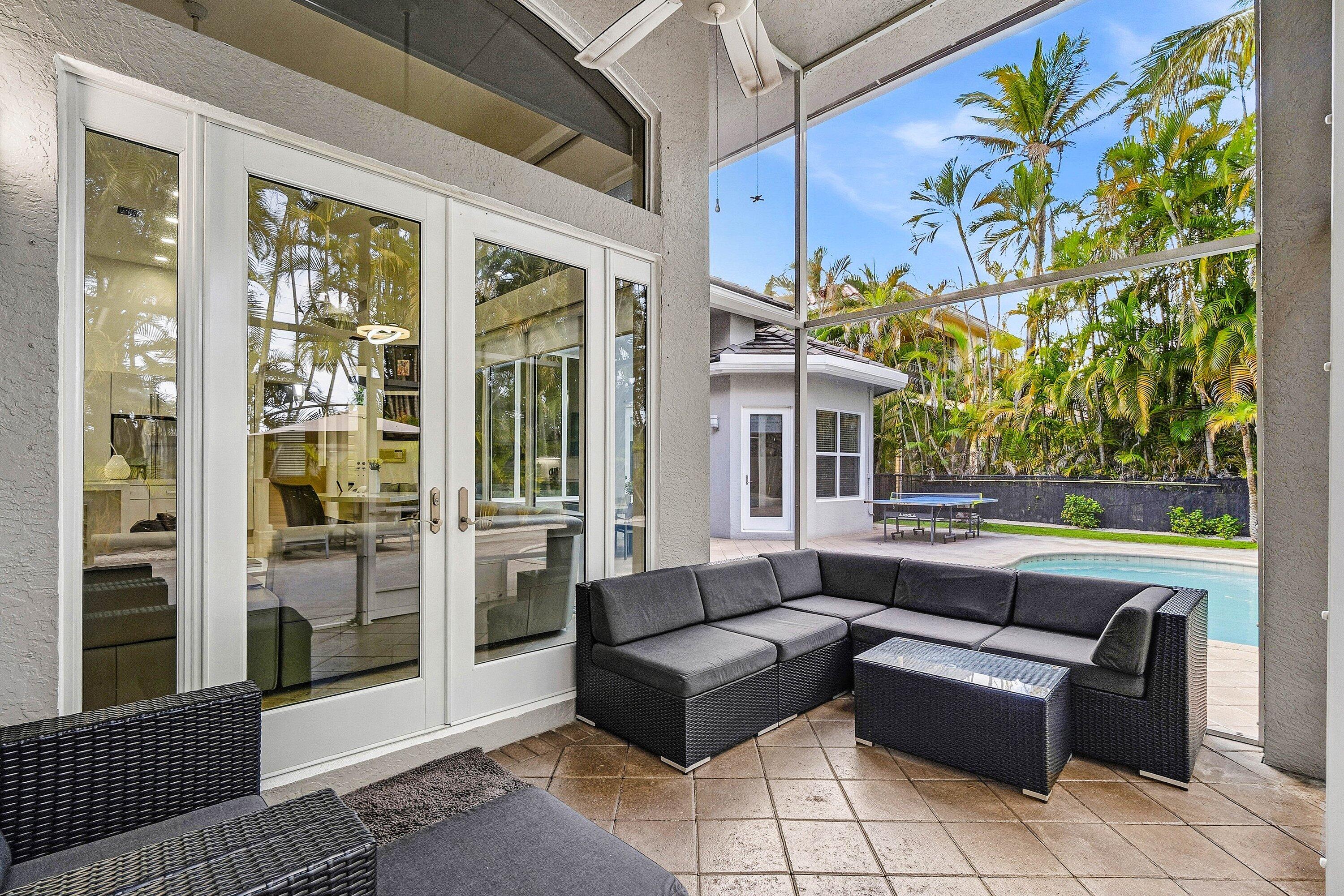 2358 Northwest 49th Lane Boca Raton, FL 33431 - Photo 41 of 47 a outdoor living space with furniture and a black umbrella