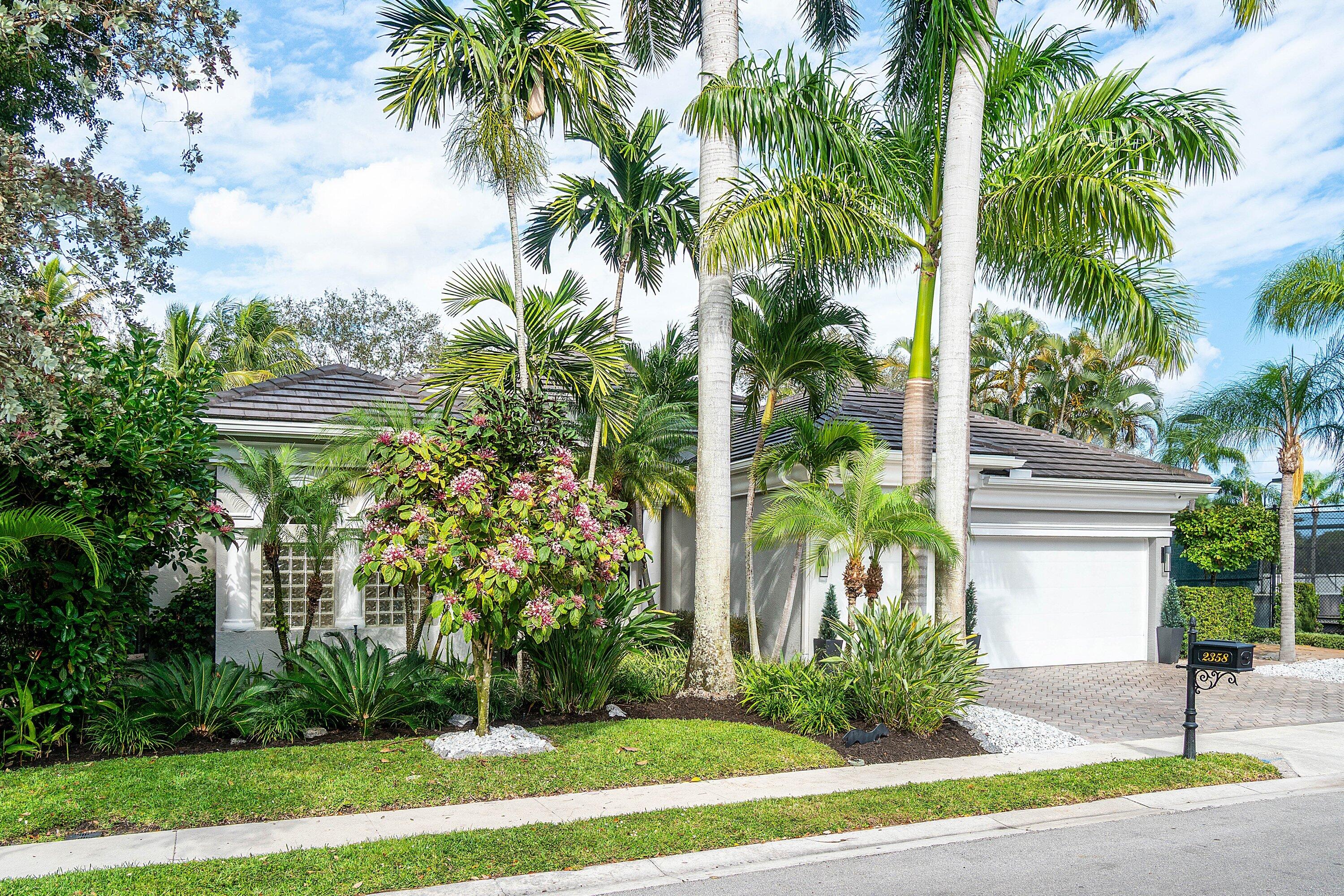 2358 Northwest 49th Lane Boca Raton, FL 33431 - Photo 45 of 47 a front view of multi story residential apartment building with yard and green space