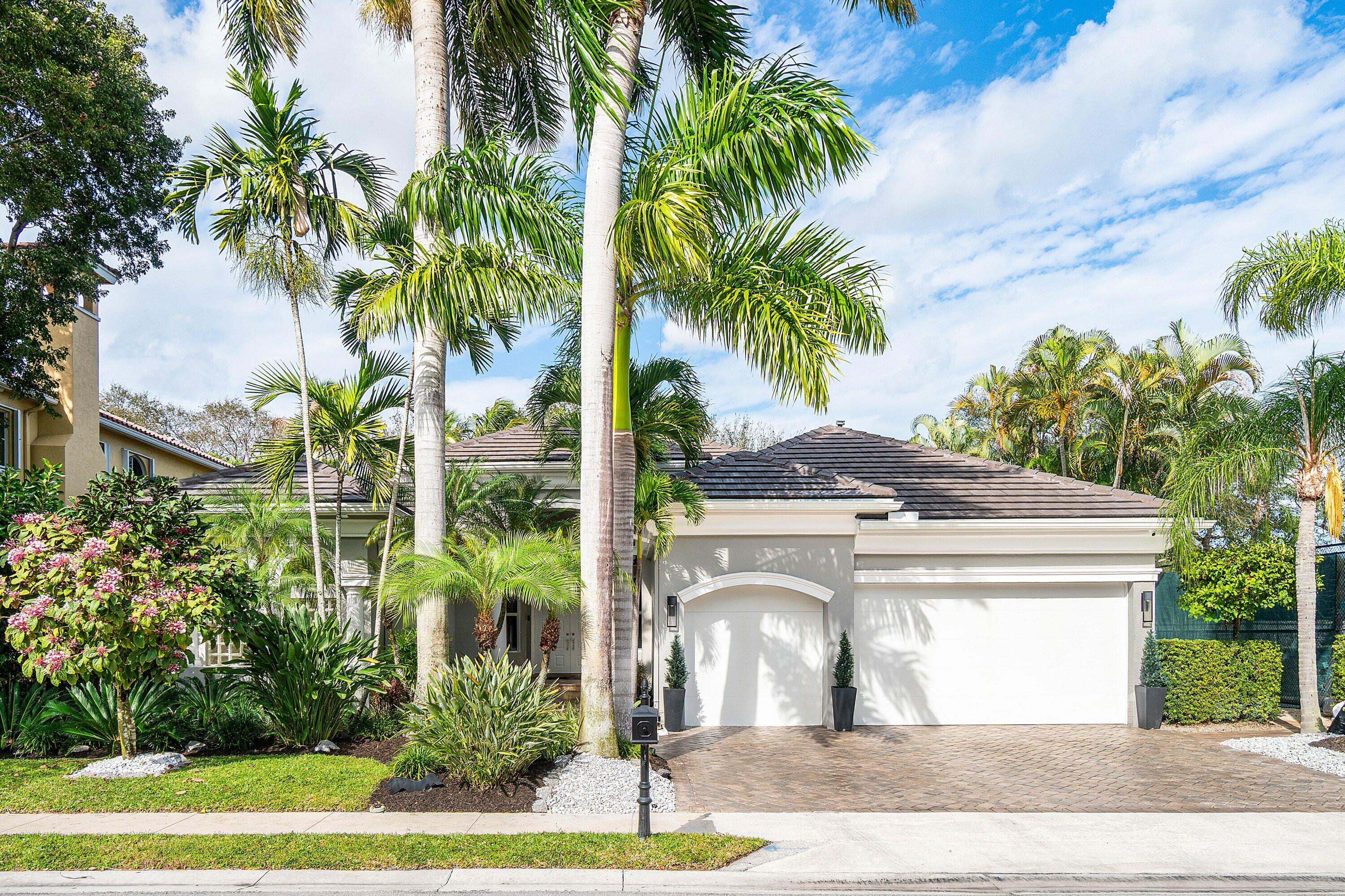 2358 Northwest 49th Lane Boca Raton, FL 33431 - Photo 46 of 47 a view of a house with a yard and palm trees