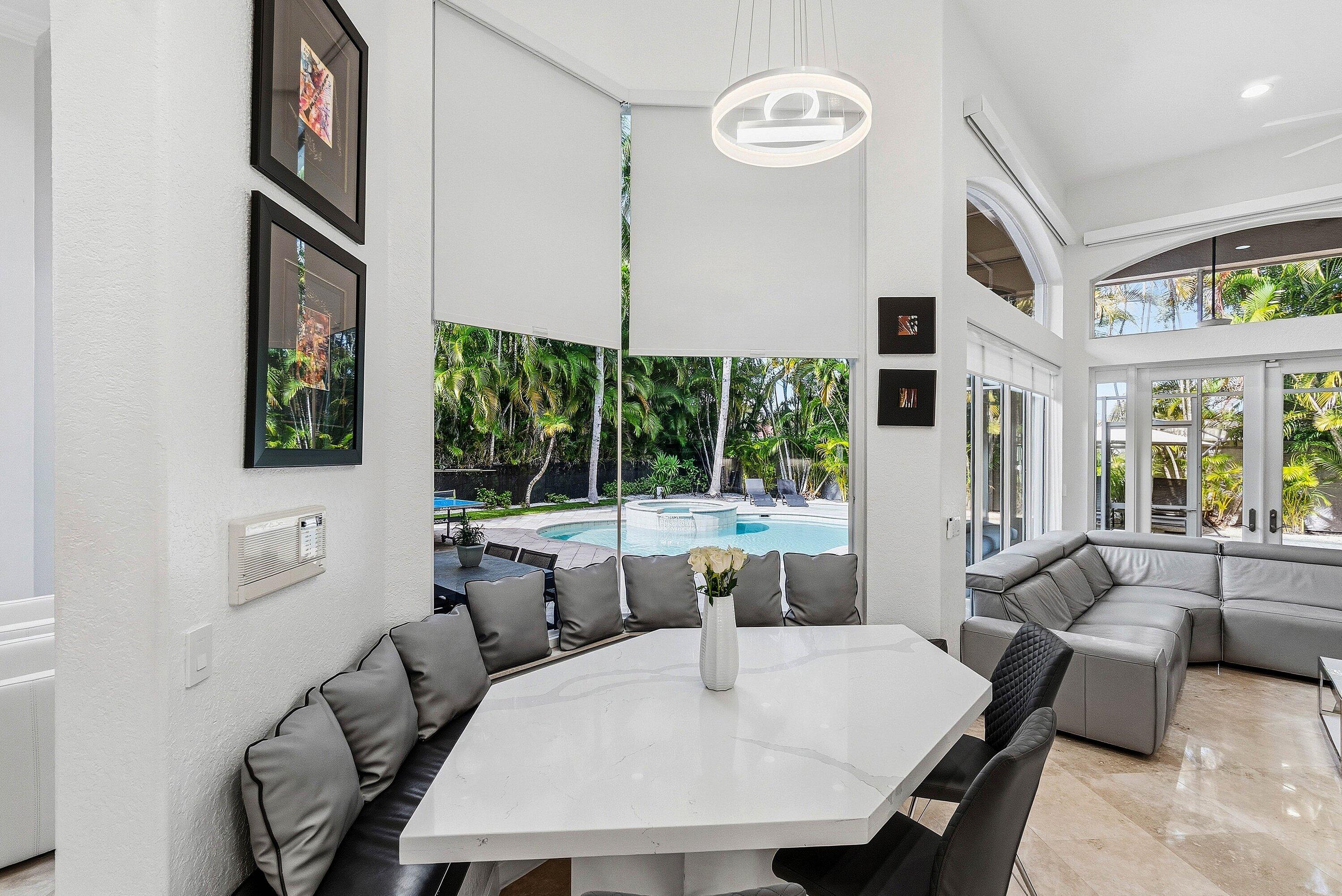 2358 Northwest 49th Lane Boca Raton, FL 33431 - Photo 6 of 47 a view of a dining room with furniture large windows and wooden floor