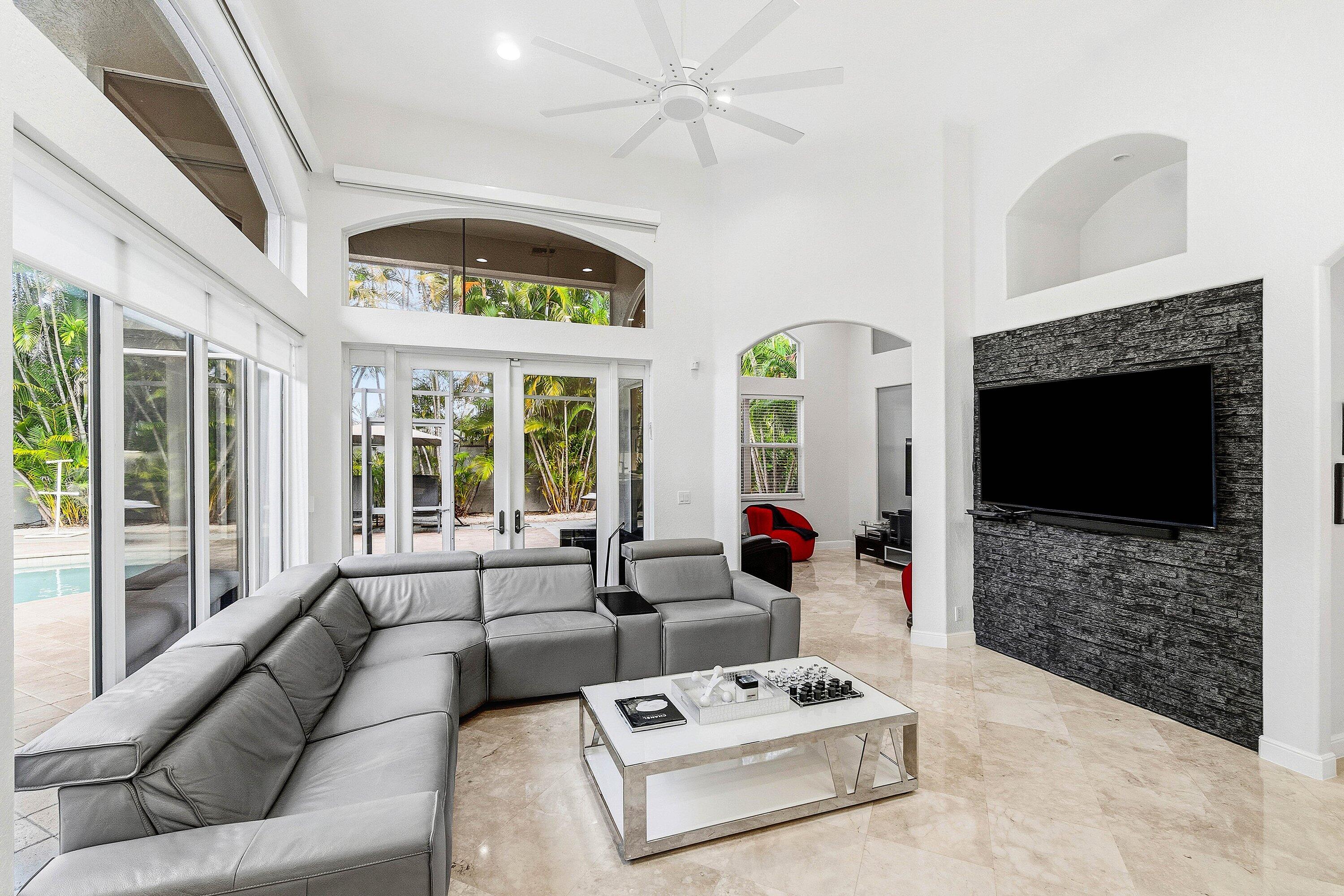 2358 Northwest 49th Lane Boca Raton, FL 33431 - Photo 9 of 47 a living room with furniture a flat screen tv and a fireplace