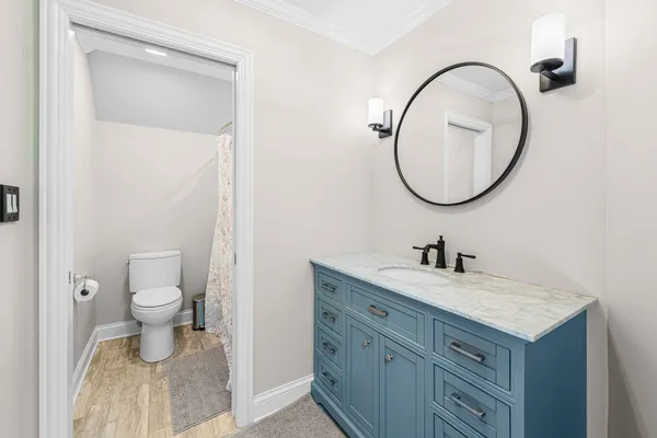 a bathroom with a toilet a sink and a mirror