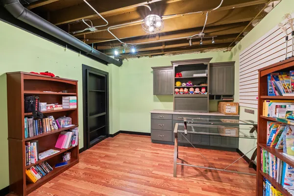 a room with bookshelf and a wooden floor