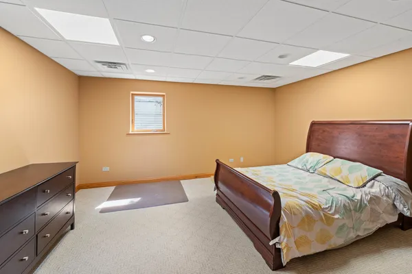 a bedroom with a bed and lamp