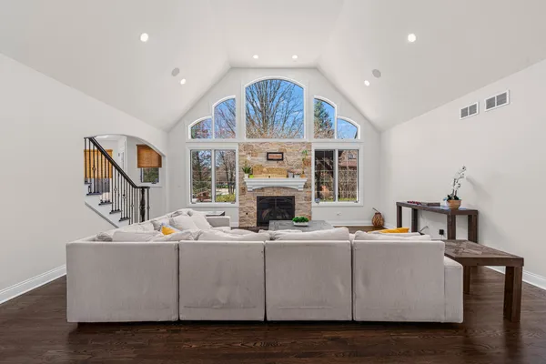 a living room with furniture a fireplace and a large mirror