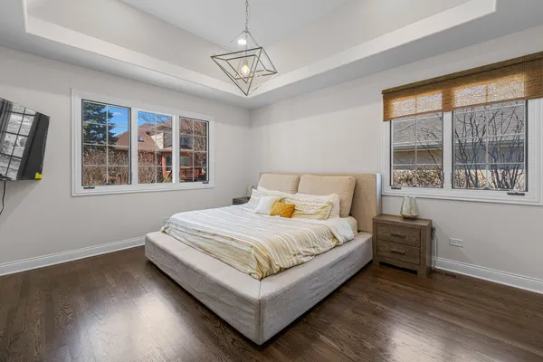 a bedroom with a bed and windows