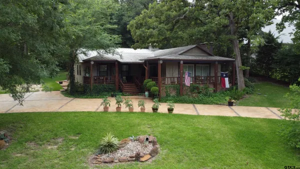 a view of a house with a yard and sitting area