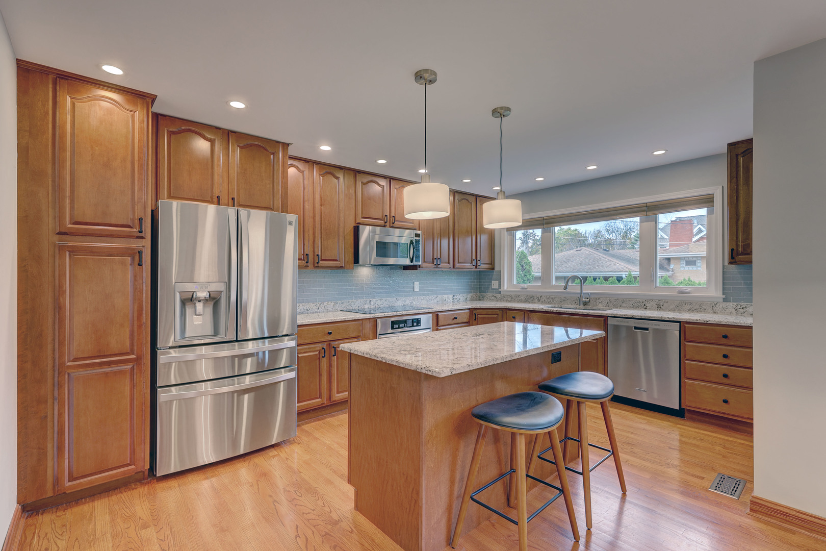 2026 Irwin Avenue Park Ridge, IL 60068 - Photo 2 of 39 a kitchen with stainless steel appliances granite countertop a refrigerator a sink dishwasher a stove and a dining table with wooden floor