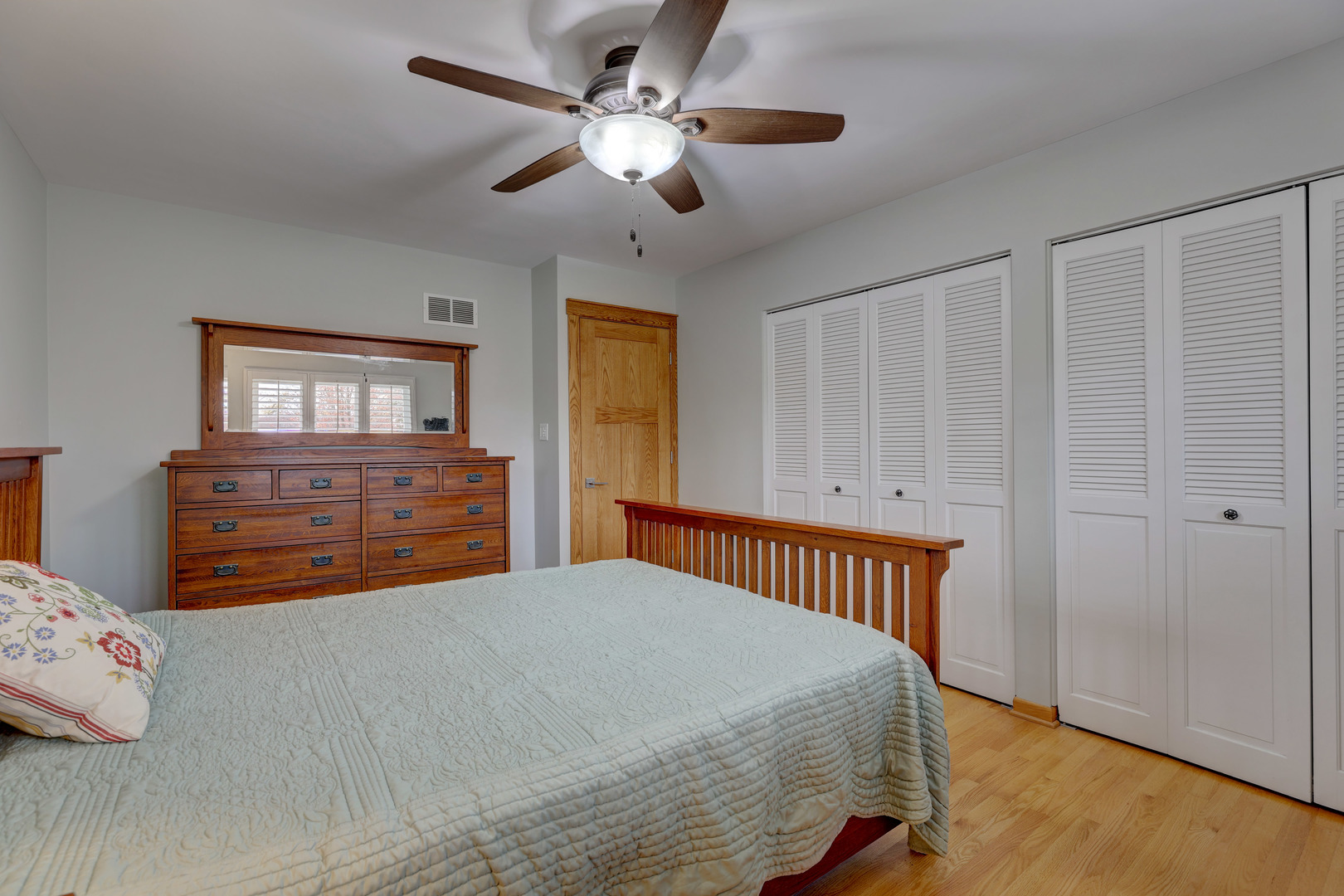 2026 Irwin Avenue Park Ridge, IL 60068 - Photo 21 of 39 a bedroom with a bed and a chandelier