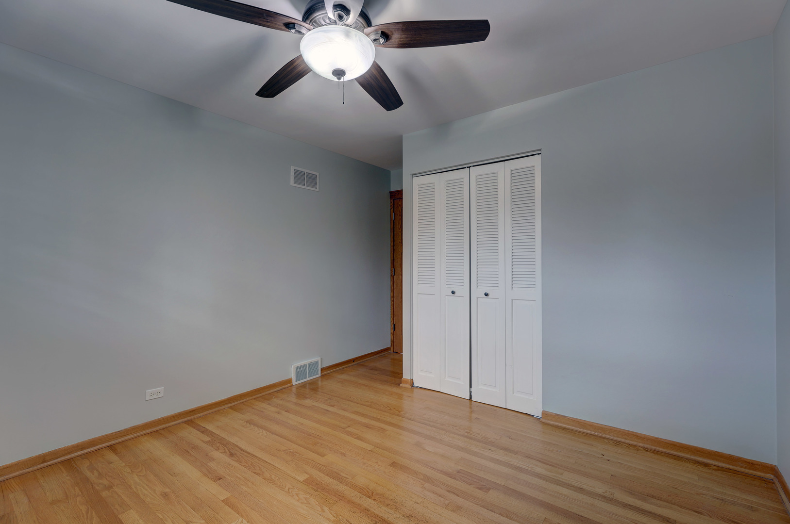 2026 Irwin Avenue Park Ridge, IL 60068 - Photo 24 of 39 an empty room with wooden floor chandelier fan and closet area