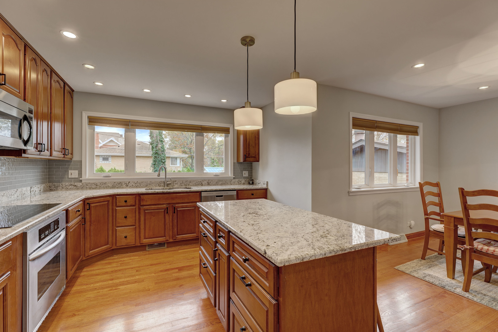 2026 Irwin Avenue Park Ridge, IL 60068 - Photo 3 of 39 a kitchen with granite countertop kitchen island a stove a sink a dining table and chairs