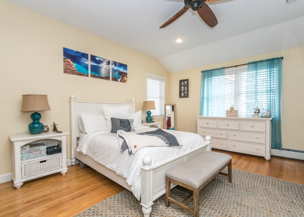 27 Sherman Street Needham, MA 02494 - Photo 10 of 32 a bedroom with a bed and a chandelier