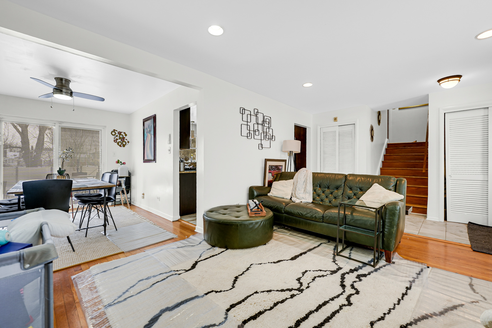 2931 Willow Road Homewood, IL 60430 - Photo 5 of 21 a living room with furniture a chandelier and a dining table with wooden floor
