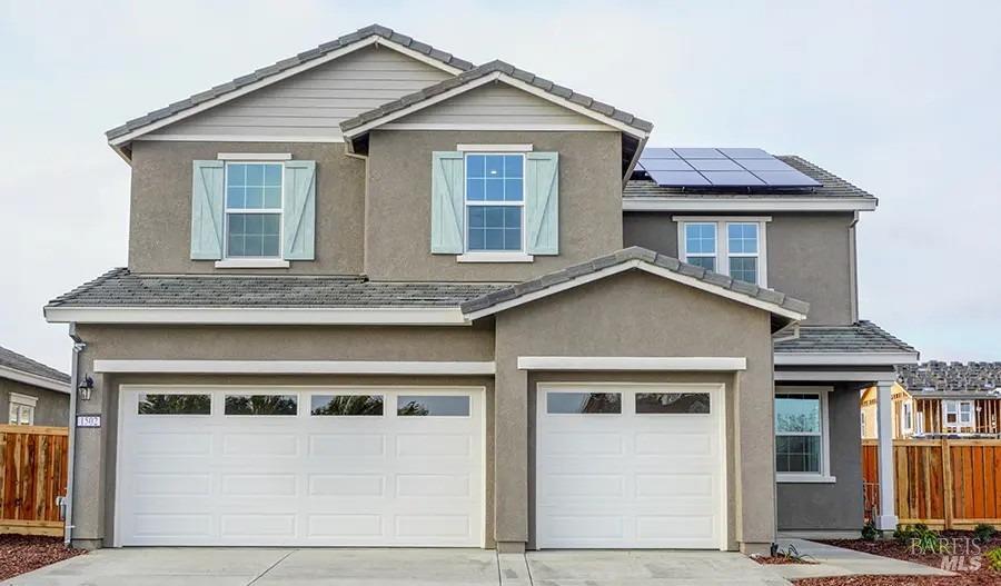 a view of a white house with large windows