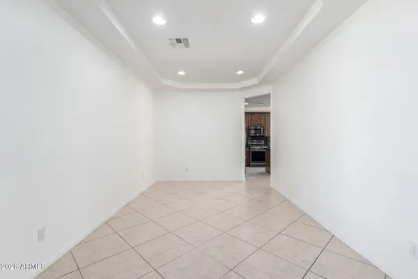 an empty room with white wall and an entryway