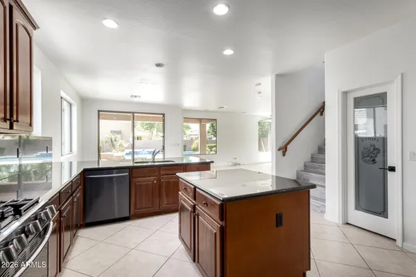 a kitchen with a sink stove and cabinets