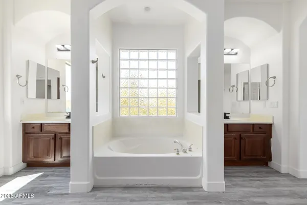 a bathroom with a bathtub shower and a sink