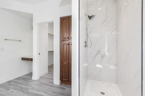 a bathroom with a shower and a glass door