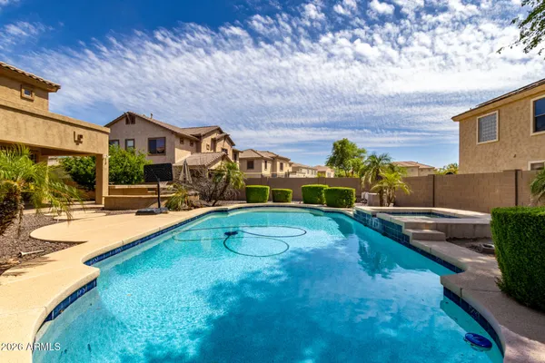 a view of a house with swimming pool and a yard