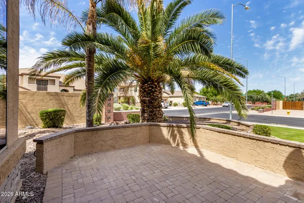 a view of a swimming pool with a patio and a yard