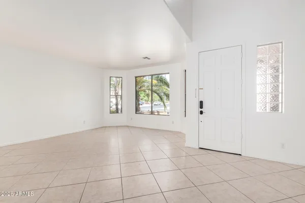an empty room with windows and closet